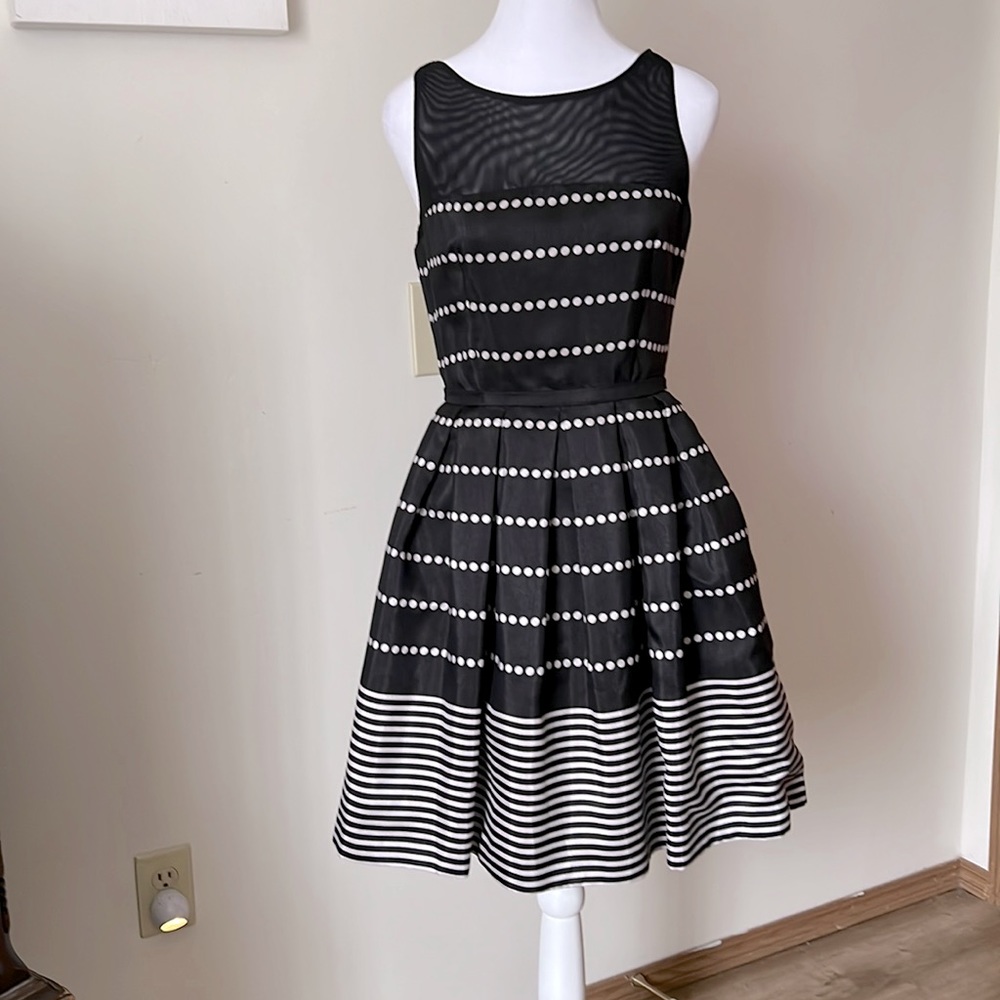 Adorable short formal dress with pockets, polka dots and a stripped trim.